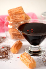 Spanish cookies Churros in a glass jar and chocolate sauce 