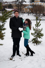 Fototapeta na wymiar A loving couple guy and girl holding a heart of snow