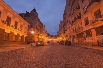 Fototapeta premium KYIV, UKRAINE - JANUARY 07, 2018: A morning view of colourful buildings on empty Andriyivskyy Uzvoz (Descent or Spusk). One of the oldest street in Kyiv.