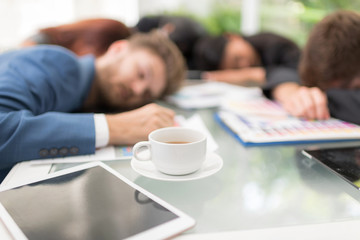 Tired business worker at conference in the office