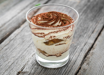 Traditional Italian dessert tiramisu in a glass.