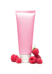 Pink cosmetic tube with raspberry on white background
