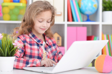 Little girl using modern laptop