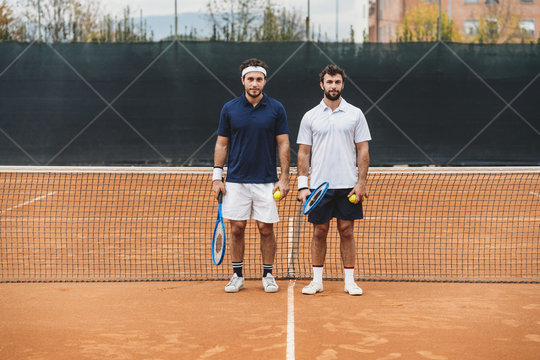 Portrait of a couple of young men engaged in a tennis match