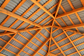 Wooden frame of new roof from inside. Construction framework.