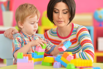 Young mother playing with son