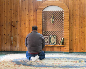 A believing muslim prays in The White Mosque - Al-Abiad in the old city of Nazareth in Israel