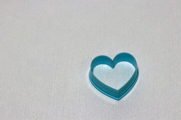 Heart shaped of dessert plastic mold in blue color isolated on white background. The concept of in love in dessert shop or Valentine day.