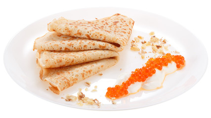 Pancakes with sour cream, red caviar and nuts on plate. Isolated on white background.