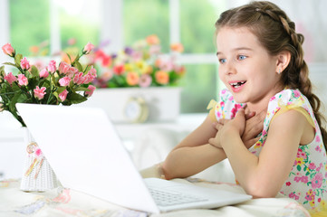 little girl using laptop