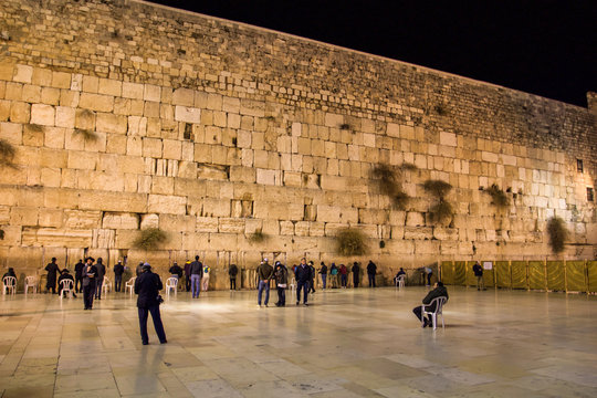 praying people at the western wall in the evening Jerusalem travel