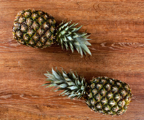 Two pineapples on a wooden background still life