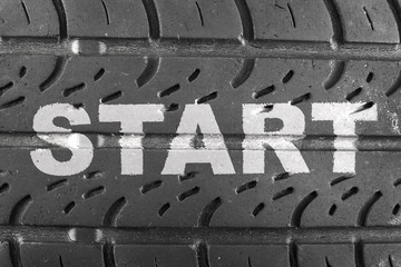 Inscription START on car tire