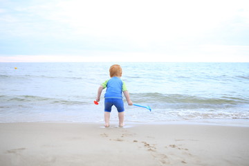 Baby playing at the sea