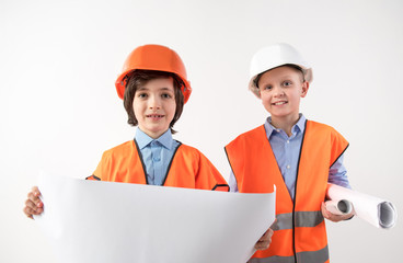 Portrait of happy friends trying on the role of superintendents. Isolated on background