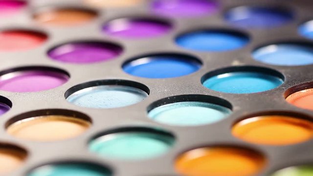 Rotating professional makeup color eyeshadows palette, closeup macro.