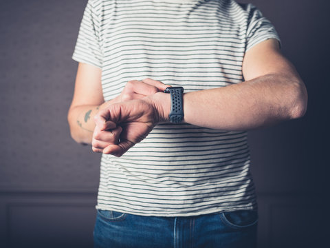 Young man with smart watch at home