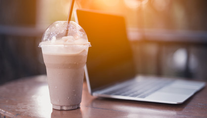 Ice Chocolate, Whip Cream, Chocolate Chip Cookie, Chopstick in Plastic Transparent Cup with Laptop Computer Notebook on Table. Set as Copy Space for Text. Idea Concept for Relax Time
