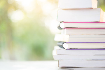 stack books with green light and bokeh background