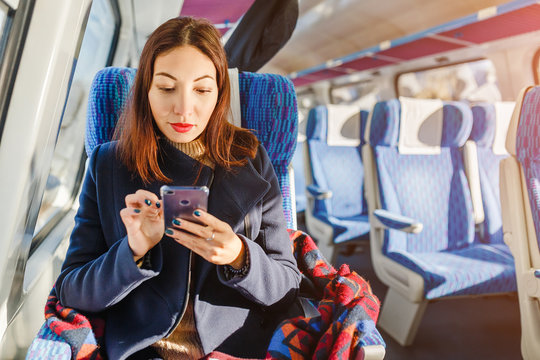 a woman is traveling on a train in a first class cabin