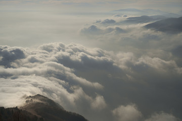  panoramic view of a cloud sky and mountain with backlight rays of sun 