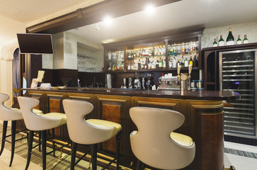 Hotel lounge bar with bottle shelfs and seats