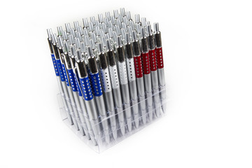 New pens in holder in rows on white background