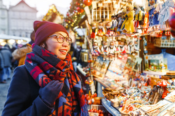 Stylish woman buys gifts and souvenirs at the Christmas market in Prague