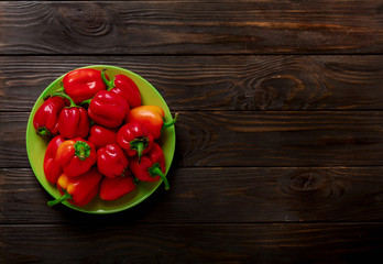 Sweet bulgarian red peppers on a dark wooden background.