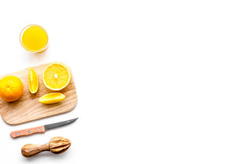 Freshly squeezed orange juice. Juicer and slices of oranges on white background top view copy space