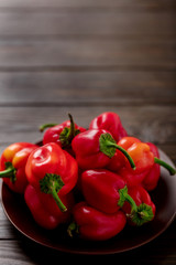 Sweet bulgarian red peppers on a dark wooden background.
