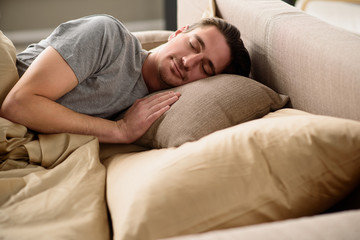 Quiet guy having nap in bedroom at home. Peace concept