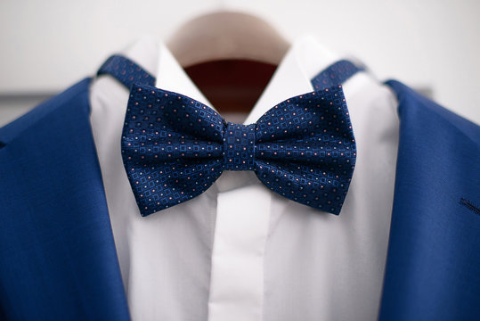 Close-up Elegant Blue Suit With White Shirt And Blue Bow Tie, In Preparation For A Formal Event, Job Interview Or A Wedding Ceremony, Or As Part Of Office Attire