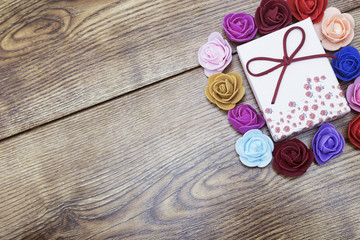 Symbol of Valentine's day. Gift box and two locks in shape of heart with roses on wooden table. Top view.