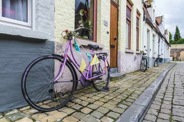 Three old bicycles parked on a street in Bruges, Belgium