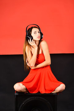 Girl with loose hair wears headphones. Music and leisure concept.