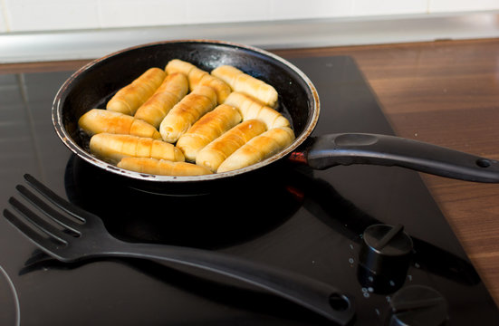 Cheese fingers in a pan with hot oil. Venezuelan typical food. tequeños