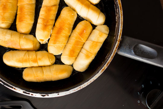Cheese fingers in a pan with hot oil. Venezuelan typical food. tequeños