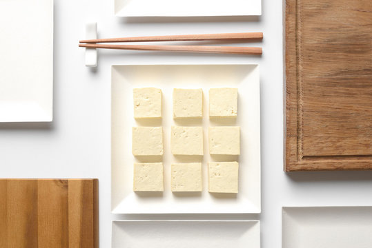 Tofu diced and served in a square plate, concept table setting