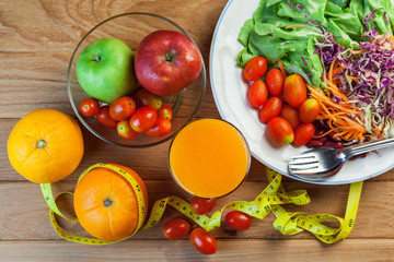Healthy concept with mixed fruits and vegetables on wooden background
