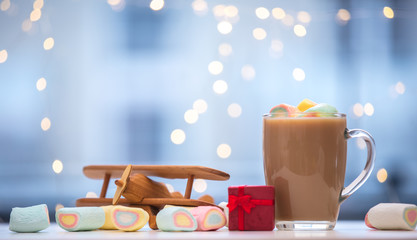 coffee with marshmallows around and airplane toy