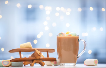 coffee with marshmallows around and airplane toy