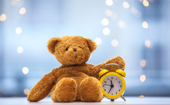 Teddy bear soft toy and little alarm clock