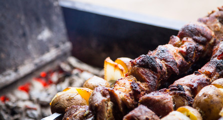pieces of meat, lard and potatoes strung on shaprur. Shish kebab traditional dish