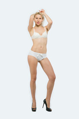 Full length portrait of a beautiful Blonde Woman poses in white underwear