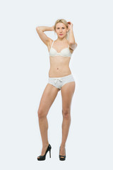 Fototapeta na wymiar Beautiful Blonde Woman poses in white underwear
