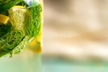 Lemonade or mojito cocktail with lemon and mint