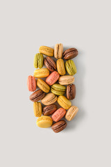 colorful almond cookies macarons on light background, unstable concept