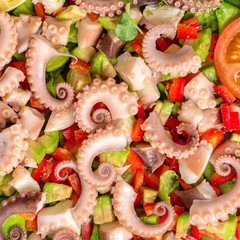 salad with tentacles of octopus, lime, avocado, red peppers and lettuce, decorated sliced tomato, restaurant seafood