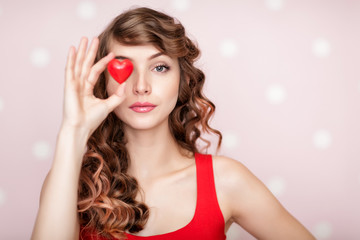 woman with red hearts on pink background.